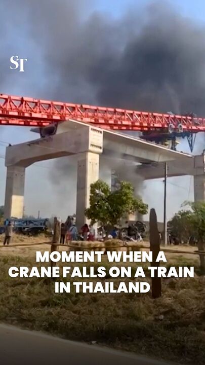 Moment when crane falls on train in Thailand
