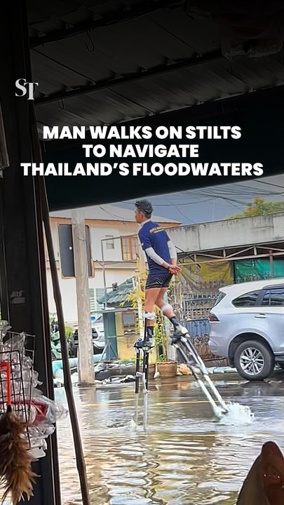 Man walks on stilts to navigate Thailand’s floodwaters