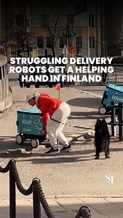 Struggling delivery robots get a human boost over a roadside curb in Finland