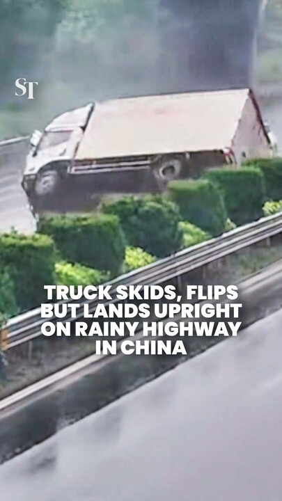 Truck miraculously lands upright after skidding and flipping on rainy highway in Zhejiang, China
