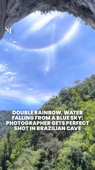 Photographer at Brazilian jungle cave captures double rainbow and water dripping from a blue sky