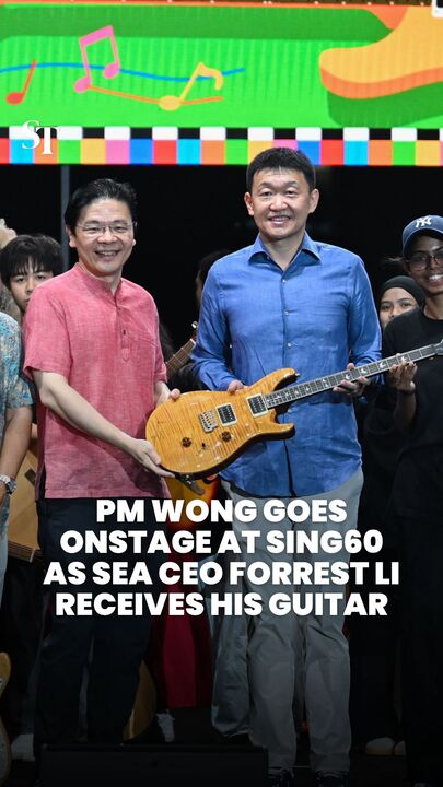 PM Wong goes onstage at Sing60 as Sea CEO Forrest Li receives his guitar