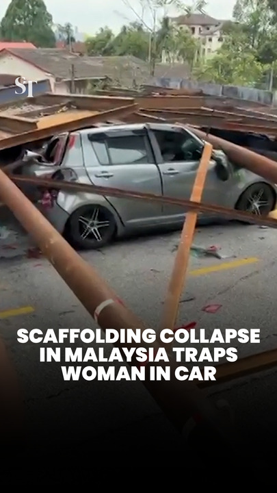 Scaffolding collapse in Malaysia traps woman in car
