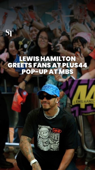 Lewis Hamilton greets fans at his Plus44 pop-up store in Marina Bay Sands Singapore