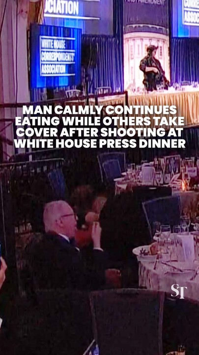 Man calmly continues his meal as others duck for cover after White House press dinner shooting