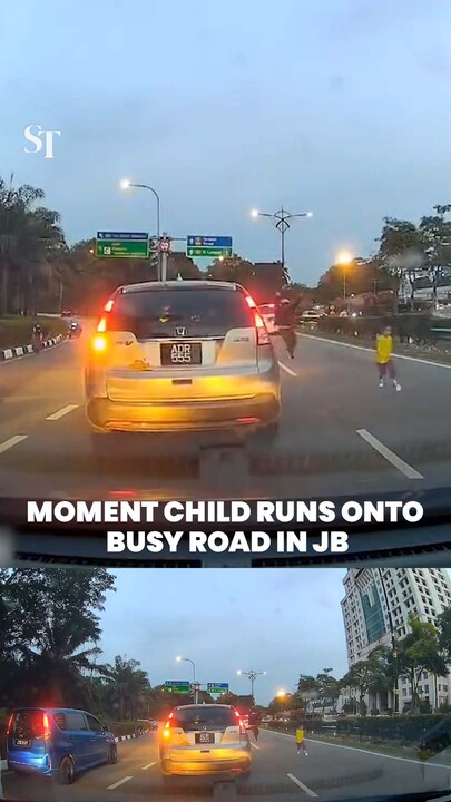 Moment child runs onto busy road in JB
