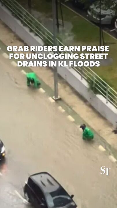 Grab riders earn praise for unclogging street drains in KL floods