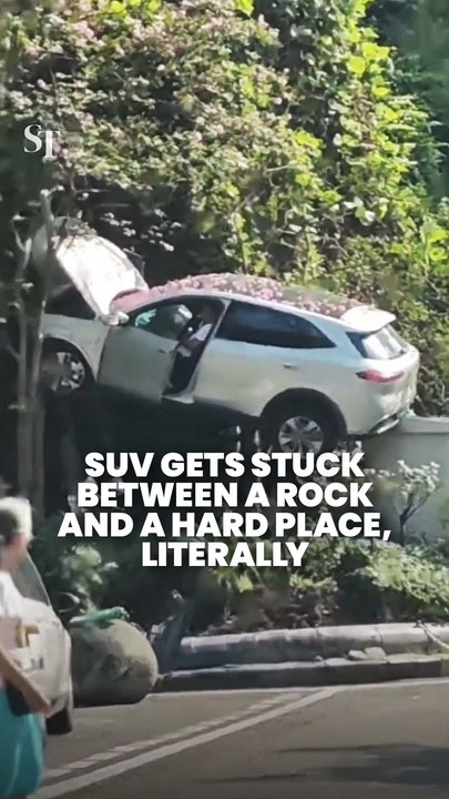 SUV left hanging after veering off road in Chongqing, China