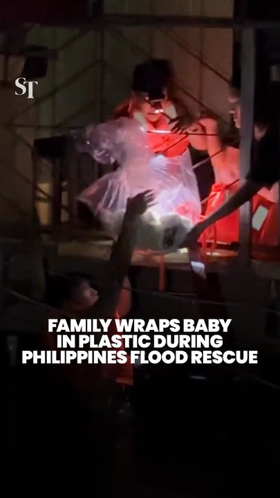 Family wraps baby in plastic to survive Philippines flood