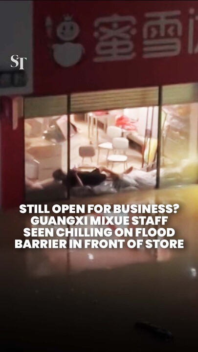Mixue staff in Guangxi seen using flood barrier as a makeshift loungechair