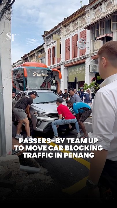 Passers-by team up to move car blocking traffic in Penang